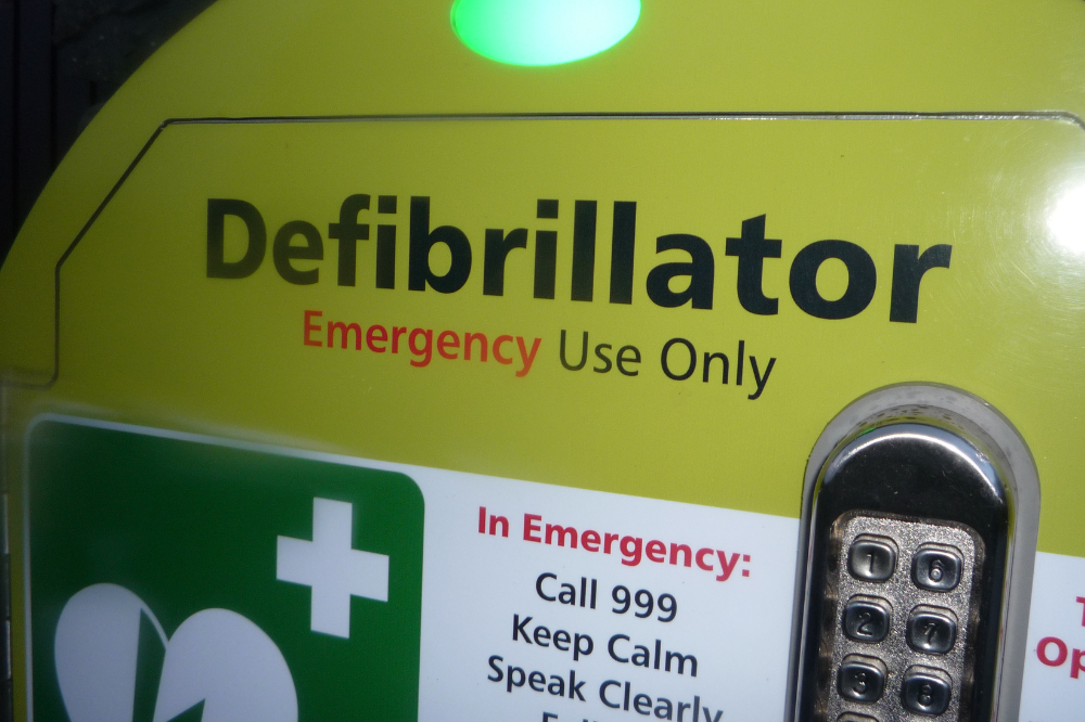 the image shows a defibrillator and instructions on how to use it