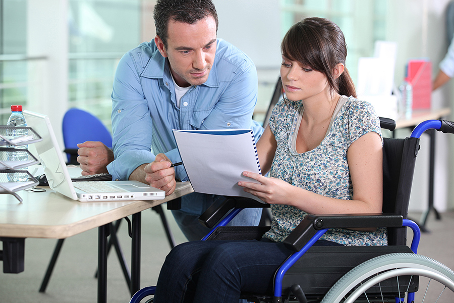 Wheelchair user looking at documents image